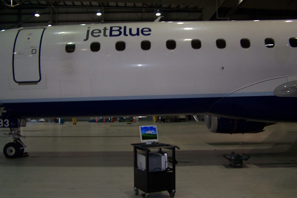 Jetblue airport with one of our powered carts for airline front and centre.
